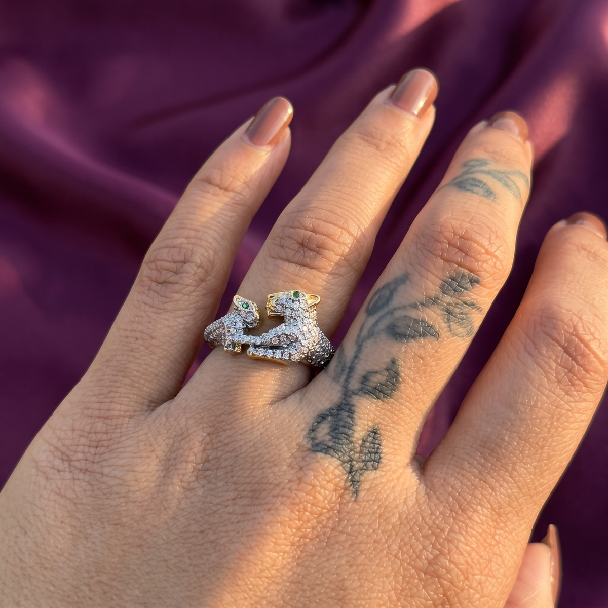 Hand wearing gold crystal leopard cub ring with green eyes – sparkling animal party wear ring, perfect gift for her