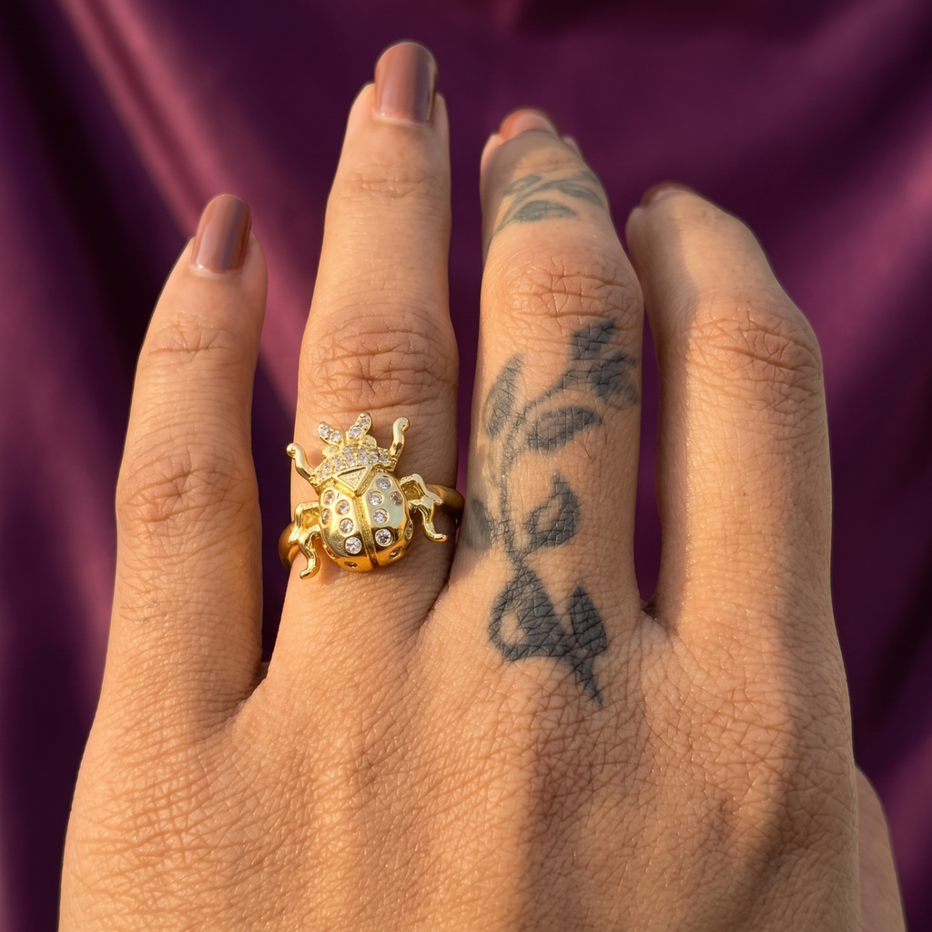 Hand wearing gold crystal scarab beetle ring – quirky insect party wear ring, perfect gift for her