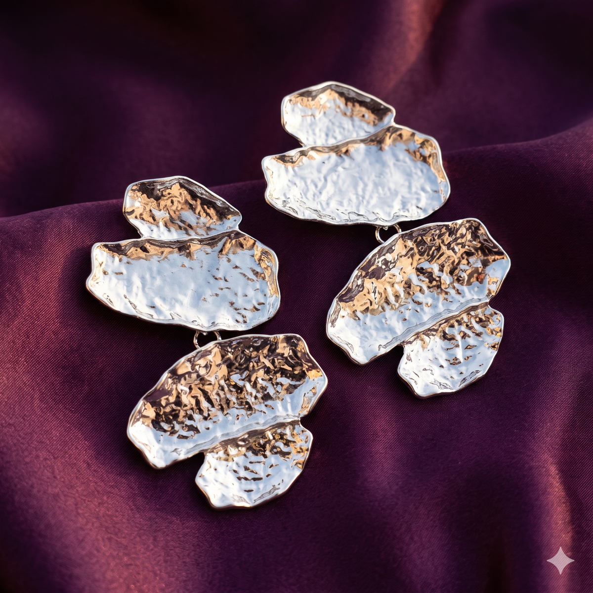 Pair of silver hammered pebble cascade drop earrings on plum satin – anti-tarnish stainless steel sculptural statement earrings by Style With Anjaly