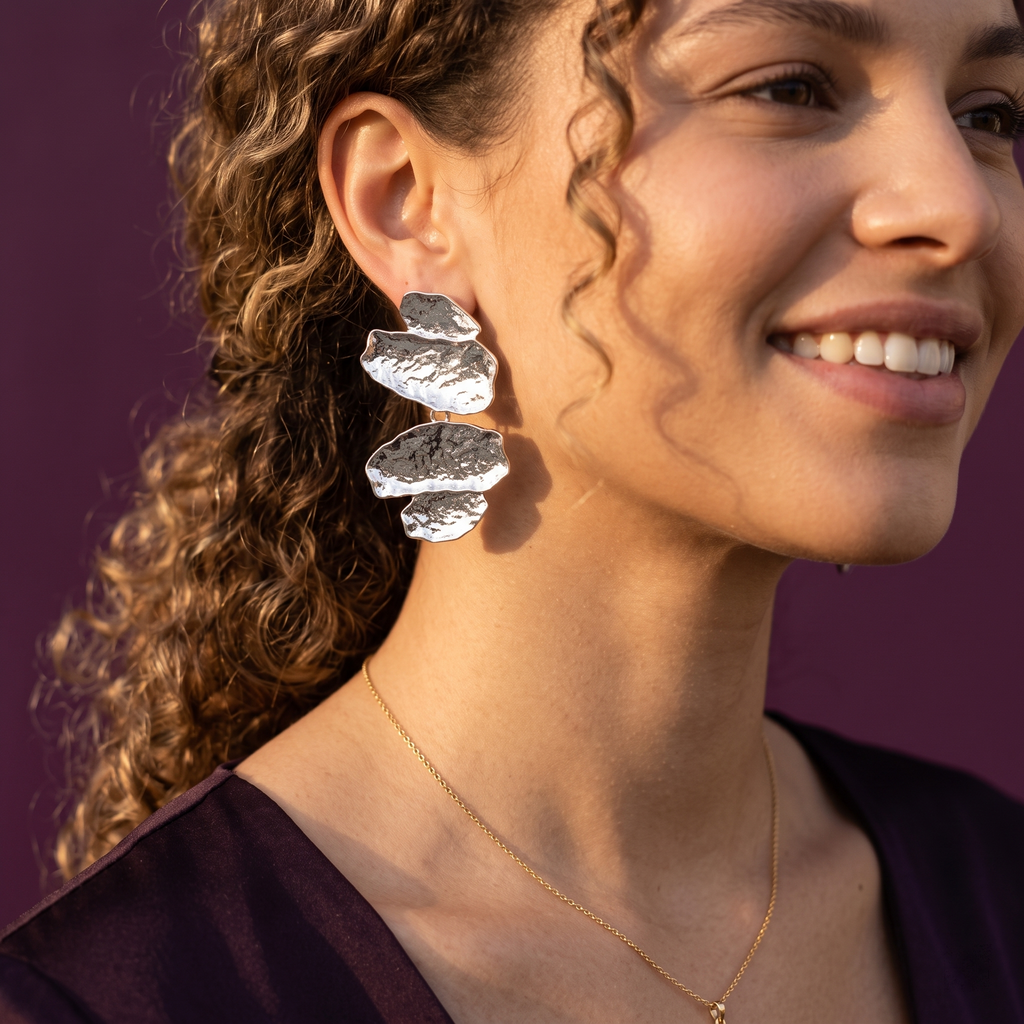Side view of silver textured pebble cascade dangle earring on ear – stainless steel sculptural earrings, perfect gift for her